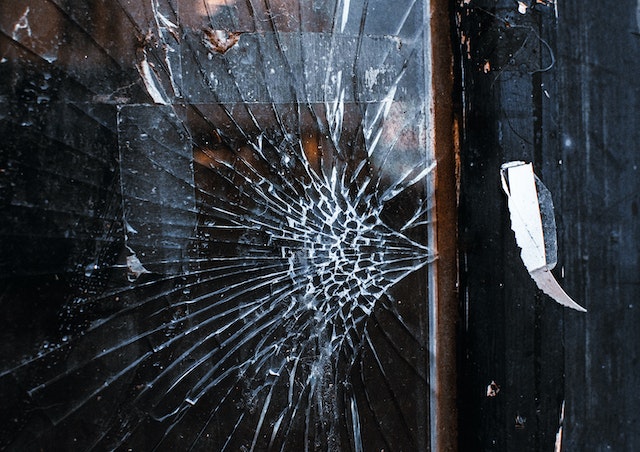 cracked window with missing shards of glass